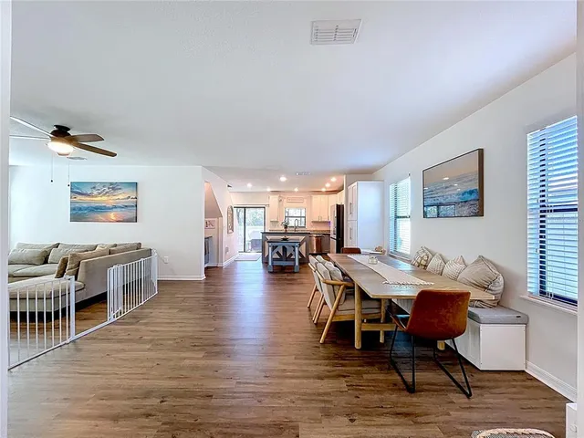 a view of a dining room with furniture window and wooden floor