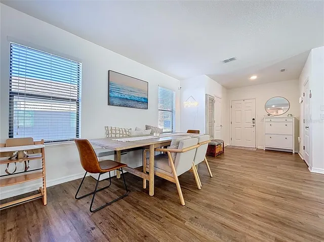 a view of a dining room with furniture and wooden floor