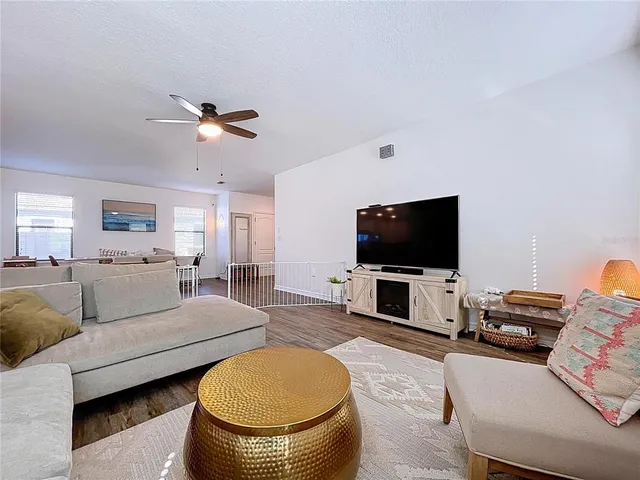 a kitchen with granite countertop a sink stove and wooden floor