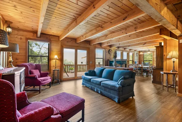 a living room with furniture a wooden floor and a large window