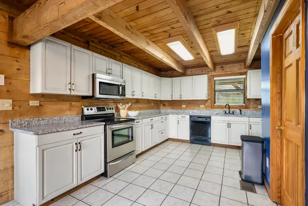 a kitchen with a stove sink and cabinets