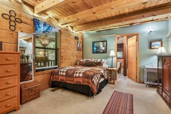 a bedroom with a bed and a mirror