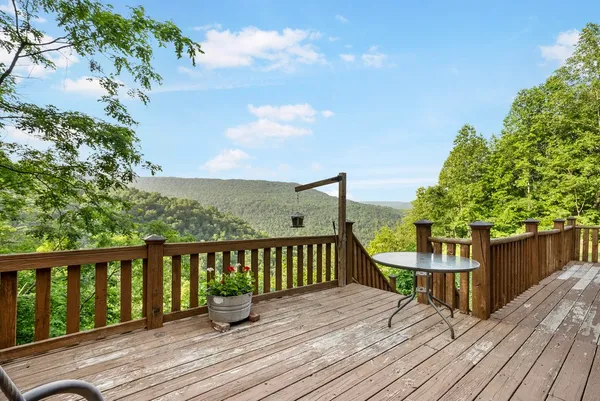 a view of a deck with wooden floor and outdoor seating