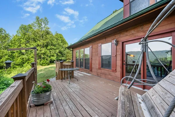 a balcony with wooden floor and fence