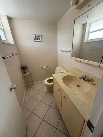 a bathroom with a sink a toilet and mirror