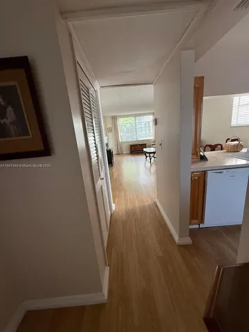 a view of a livingroom with wooden floor and furniture