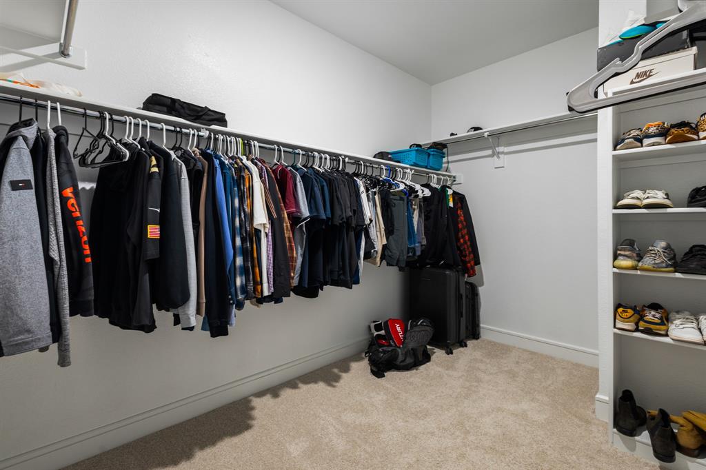 1926 Honey Crk Road Forney, TX 75126 - Photo 18 of 29 a view of walk in closet with clothes and shoes