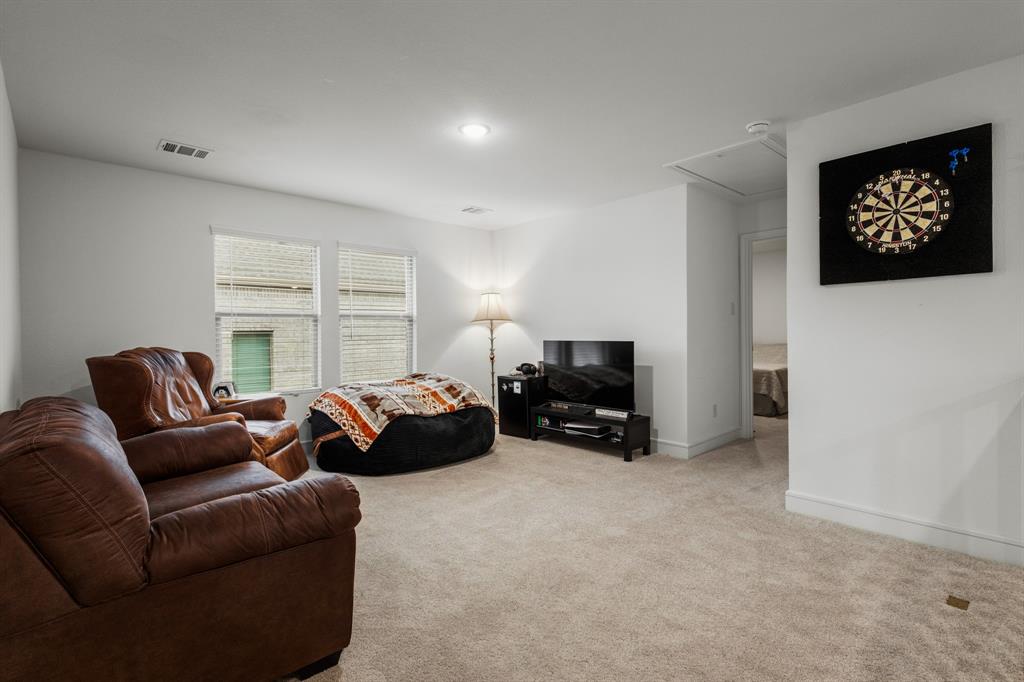 1926 Honey Crk Road Forney, TX 75126 - Photo 21 of 29 a living room with furniture a large window and a flat screen tv