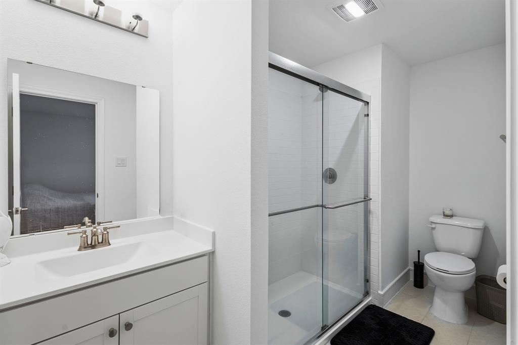 1926 Honey Crk Road Forney, TX 75126 - Photo 25 of 29 a bathroom with a granite countertop sink toilet a mirror and shower