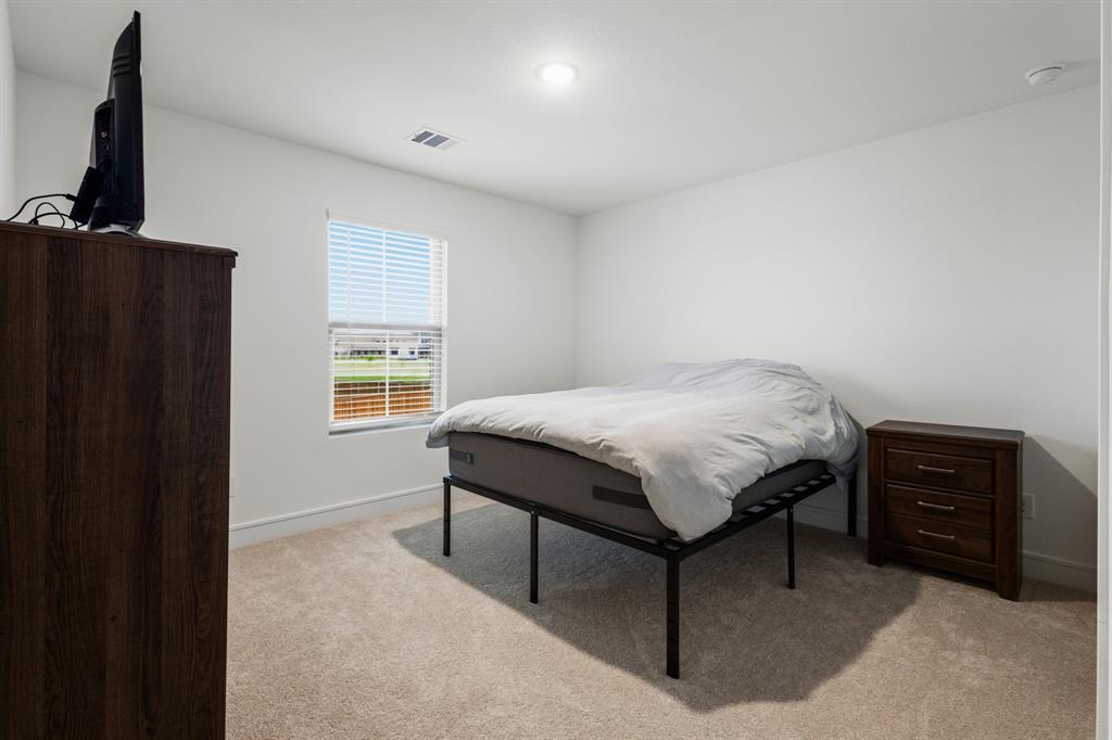 1926 Honey Crk Road Forney, TX 75126 - Photo 26 of 29 a bedroom with a bed window and dresser