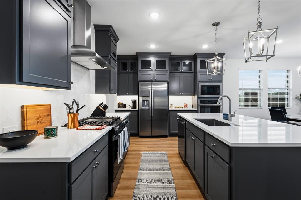1926 Honey Crk Road Forney, TX 75126 - Photo 8 of 29 a kitchen with stainless steel appliances a sink stove top oven and cabinets