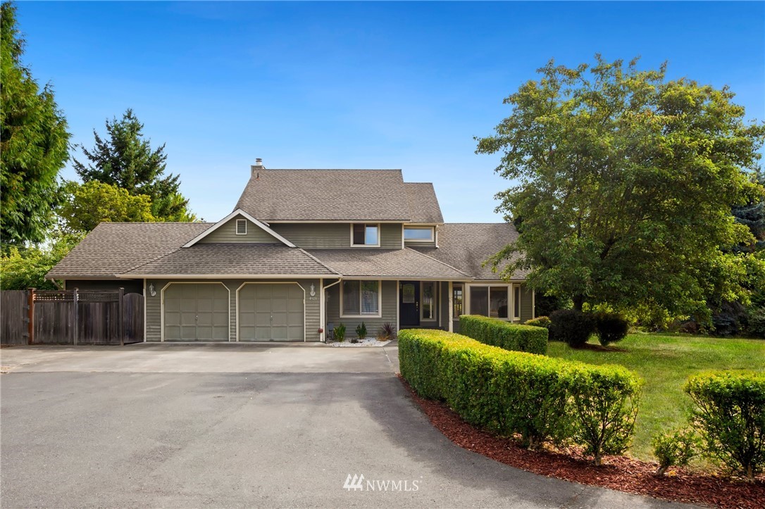 4521 244th Street Southeast Bothell, WA 98021 - Photo 1 of 38 a front view of a house with a garden
