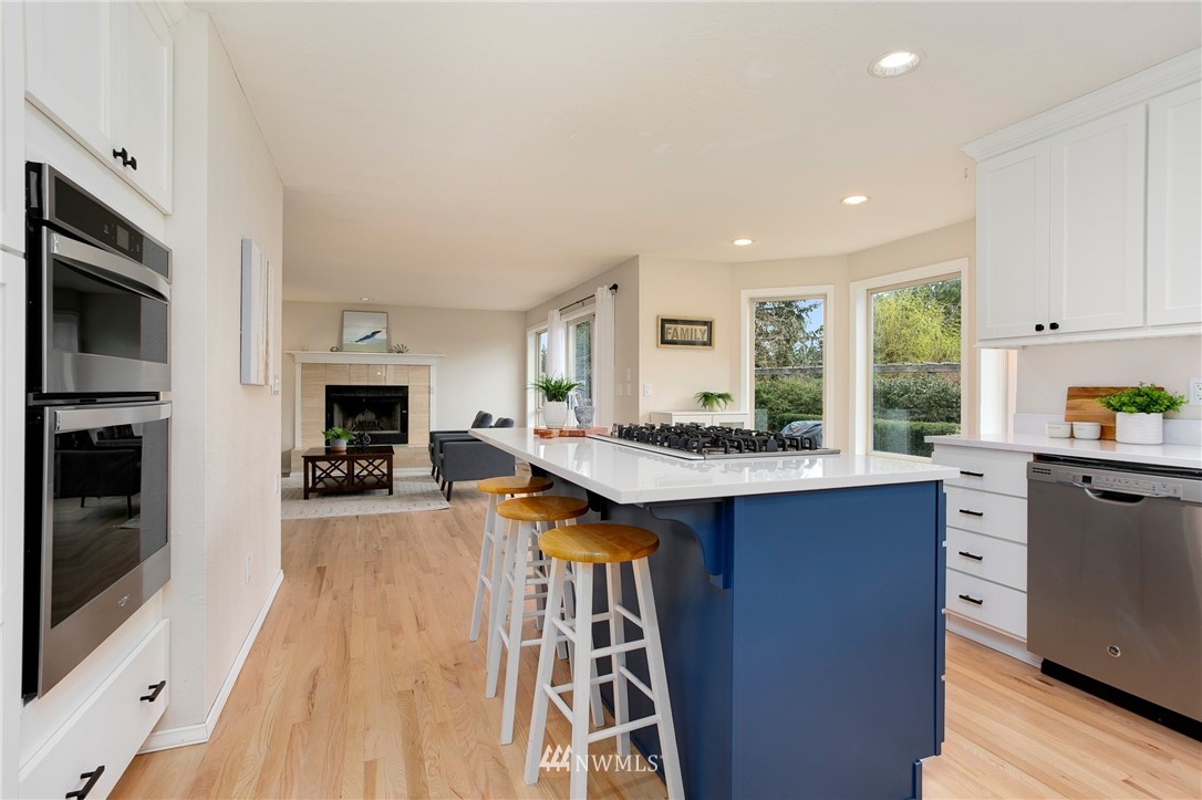 4521 244th Street Southeast Bothell, WA 98021 - Photo 11 of 38 a kitchen with granite countertop a stove top oven sink and cabinets