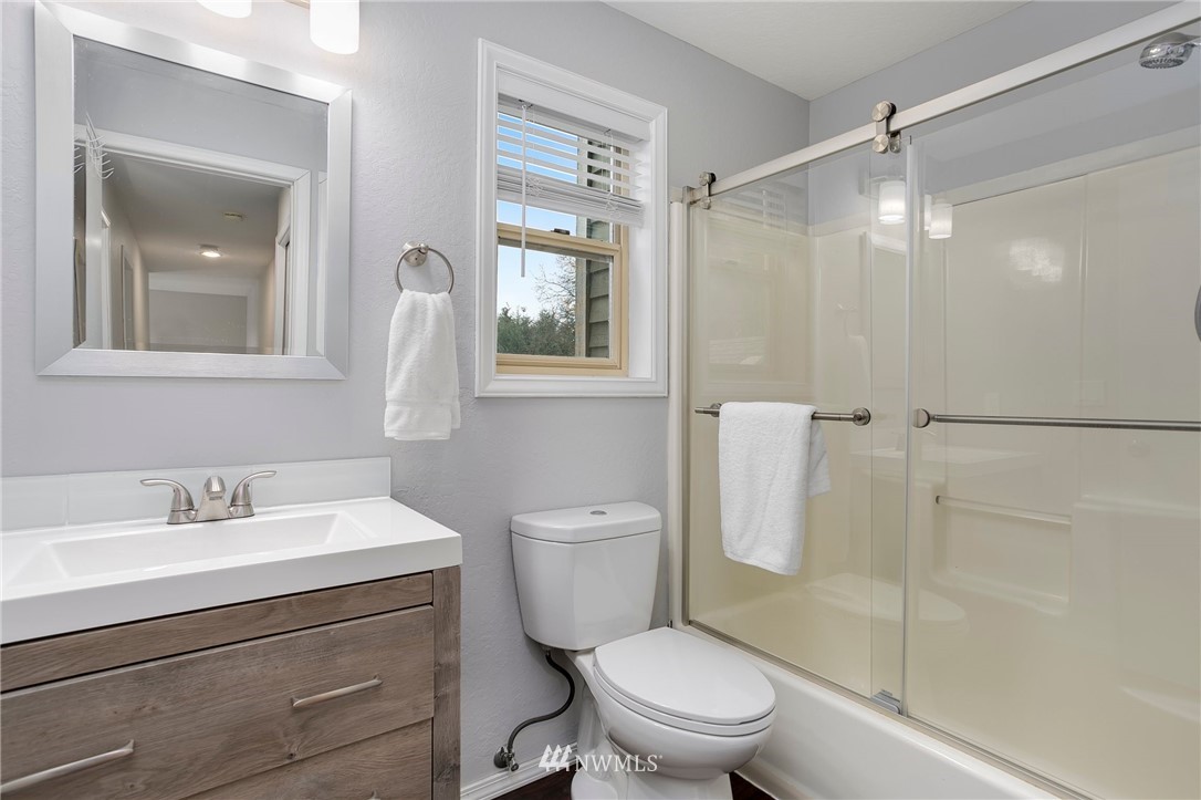 4521 244th Street Southeast Bothell, WA 98021 - Photo 19 of 38 a bathroom with a sink a toilet and shower