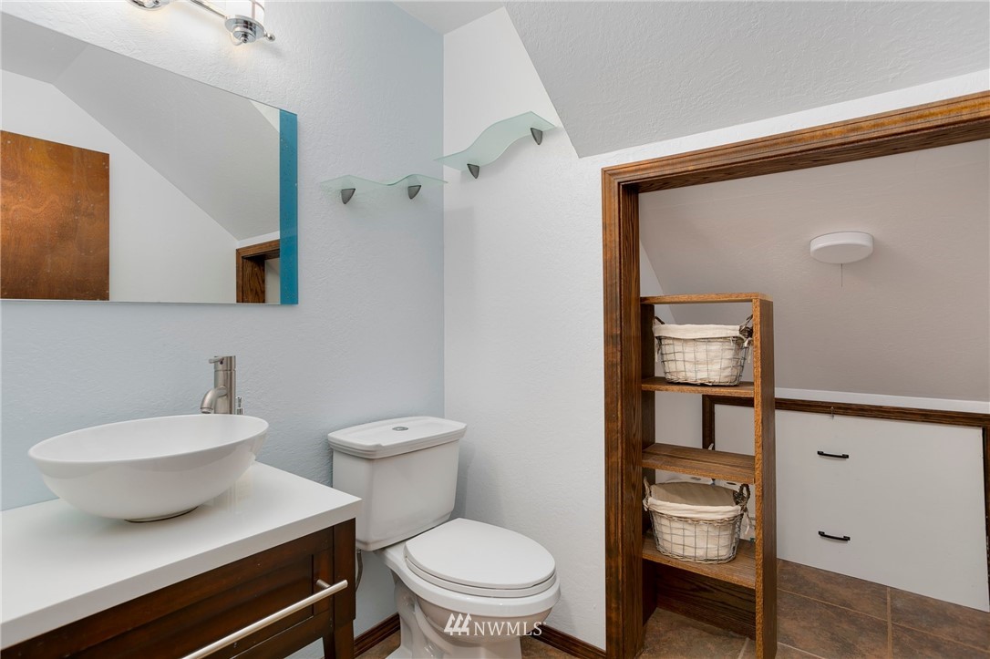 4521 244th Street Southeast Bothell, WA 98021 - Photo 21 of 38 a bathroom with a toilet a sink and mirror
