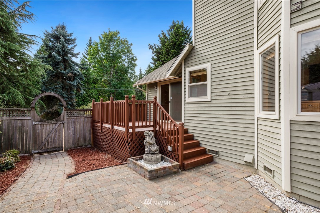 4521 244th Street Southeast Bothell, WA 98021 - Photo 25 of 38 a view of a wooden fence with a bench in the patio