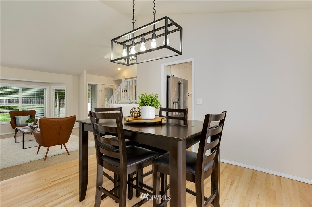 4521 244th Street Southeast Bothell, WA 98021 - Photo 5 of 38 a view of a dining room with furniture window and wooden floor