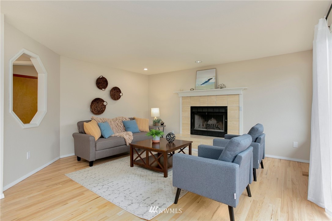 4521 244th Street Southeast Bothell, WA 98021 - Photo 6 of 38 a living room with furniture and a fireplace
