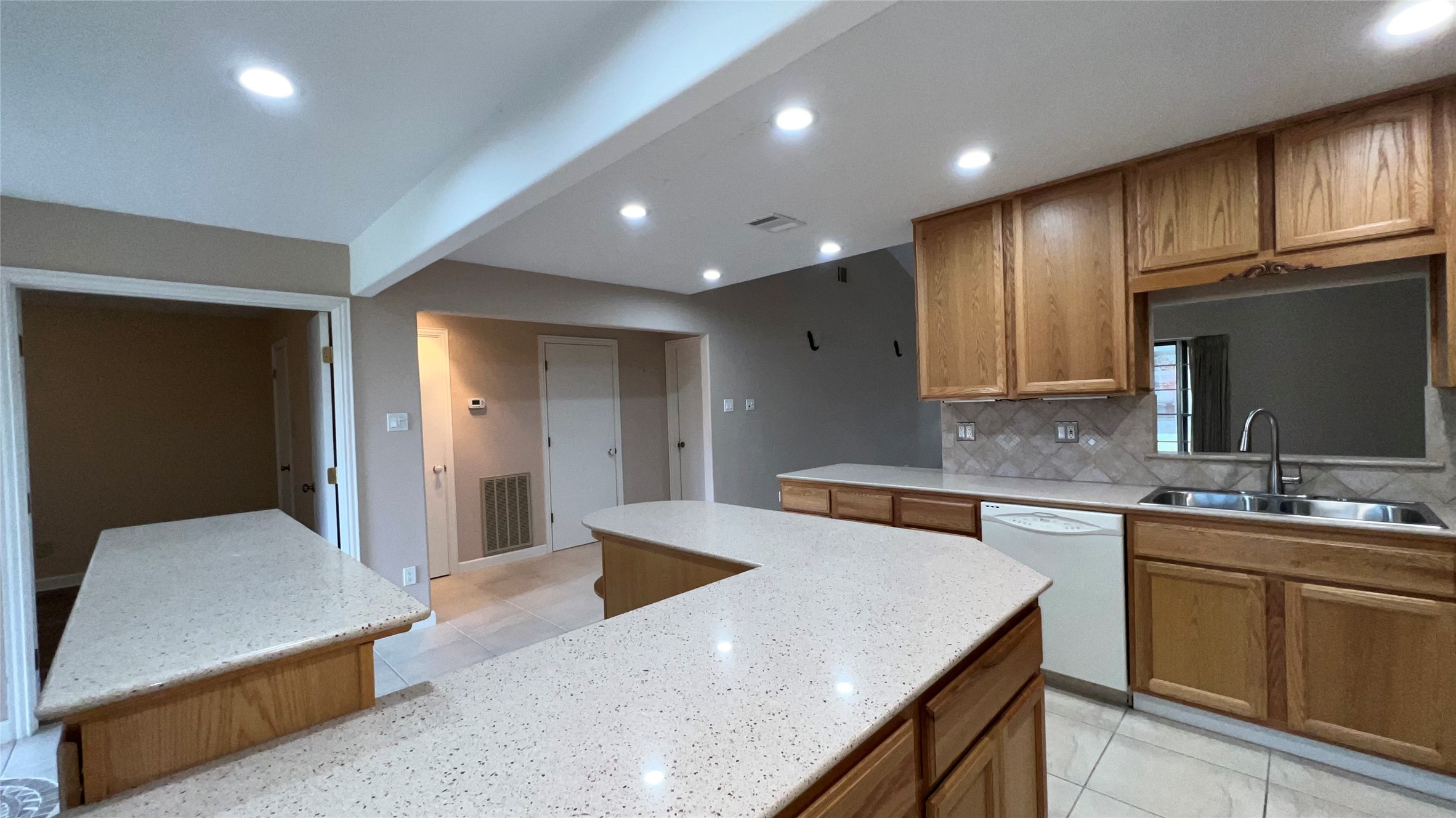 6615 Deer Ridge Lane Houston, TX 77086 - Photo 11 of 38 a kitchen with a sink dishwasher a stove and a refrigerator with wooden cabinets