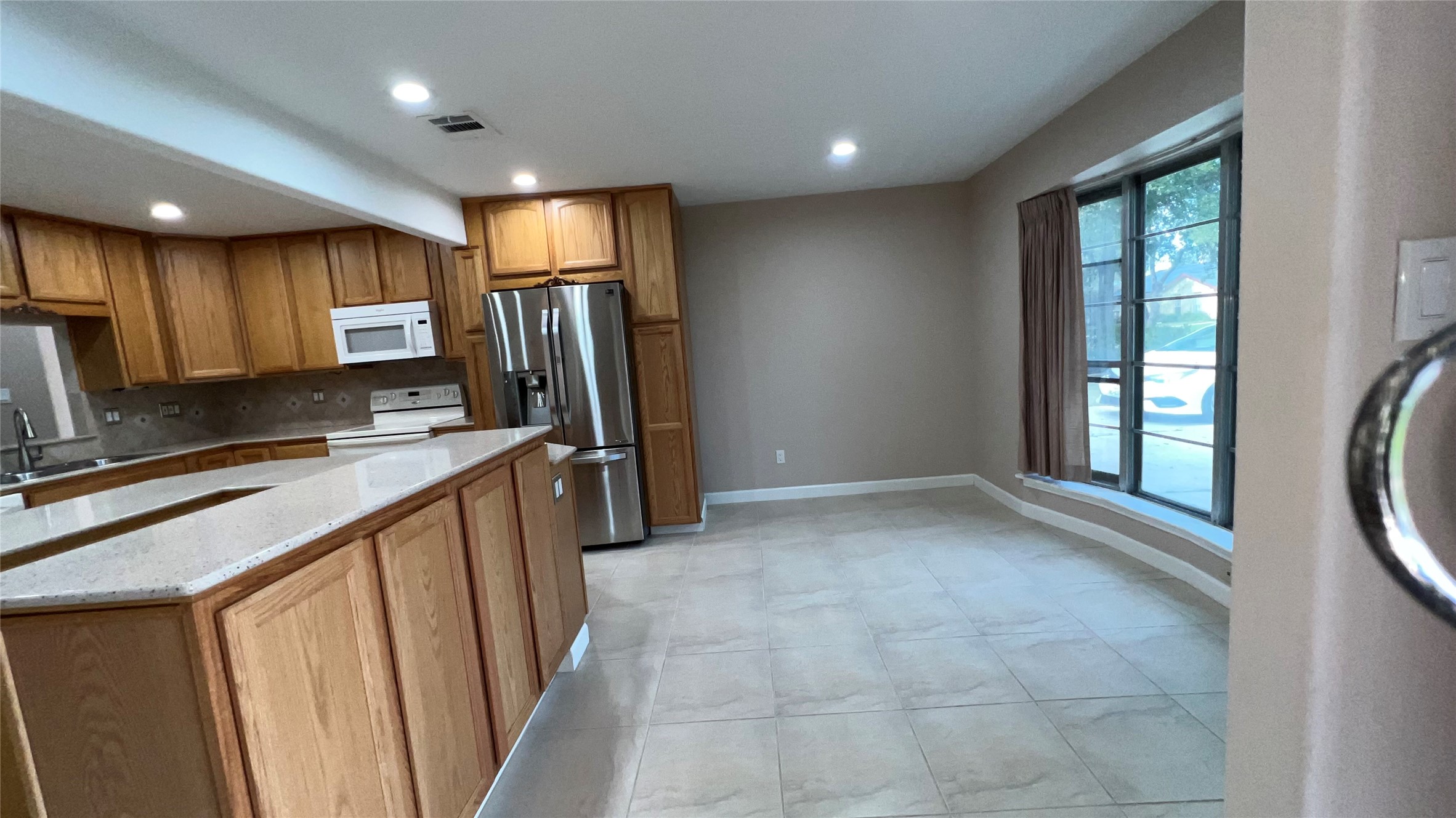 6615 Deer Ridge Lane Houston, TX 77086 - Photo 15 of 38 a kitchen with stainless steel appliances granite countertop a refrigerator and a sink