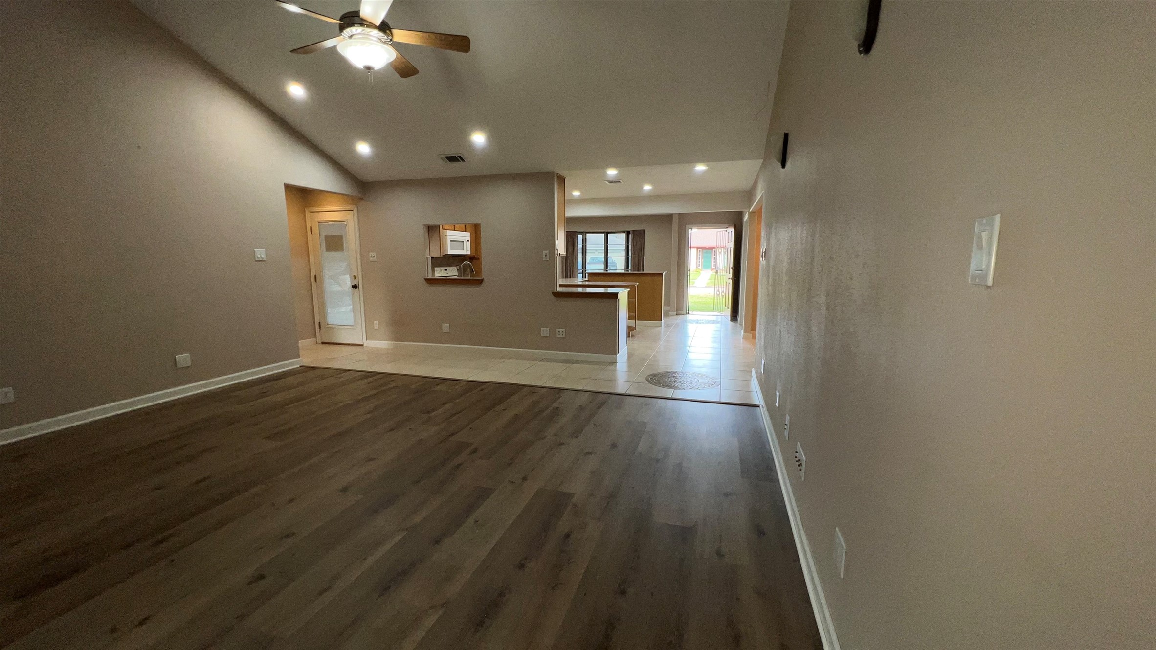 6615 Deer Ridge Lane Houston, TX 77086 - Photo 17 of 38 an empty room with wooden floor and windows