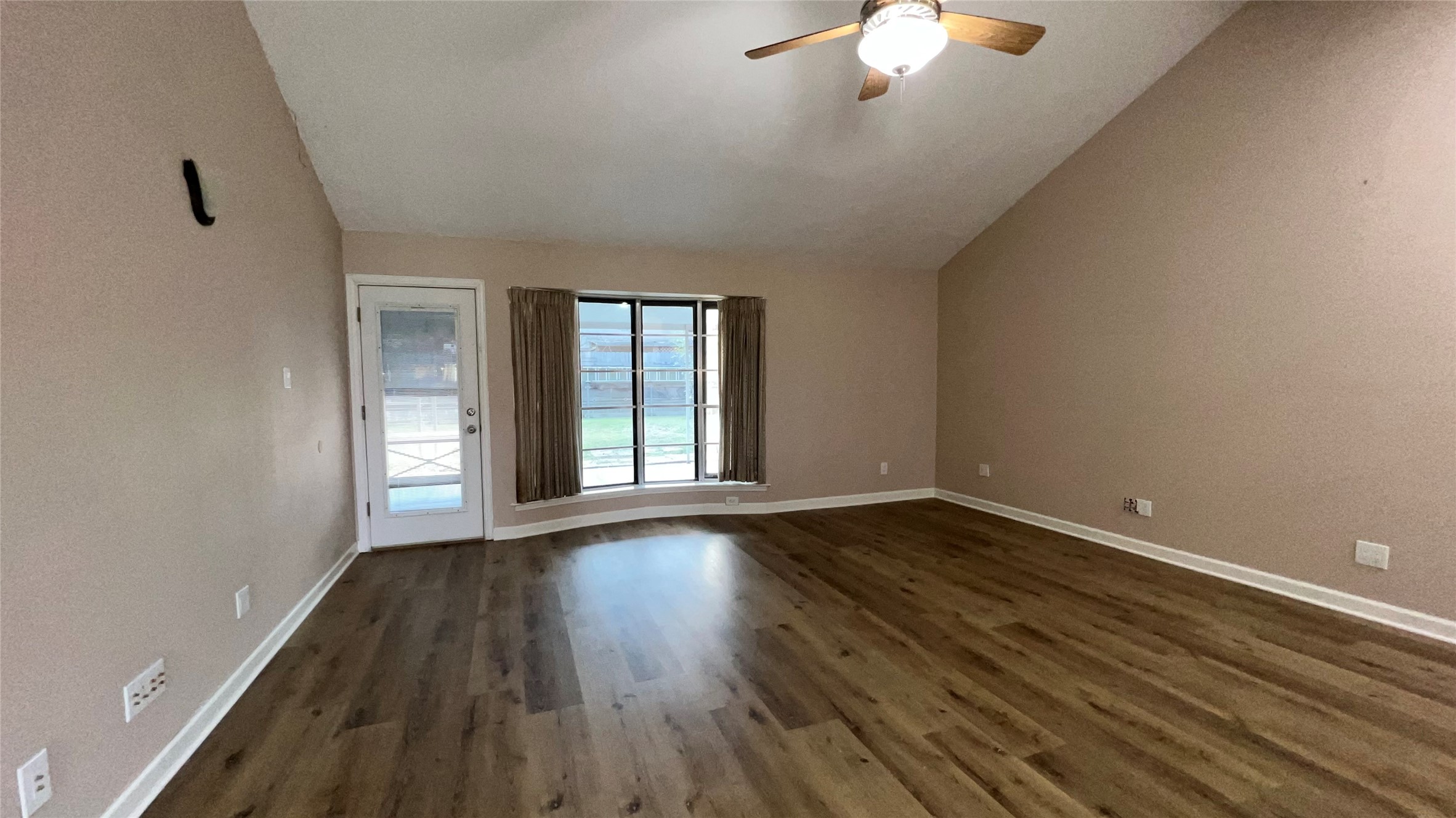 6615 Deer Ridge Lane Houston, TX 77086 - Photo 23 of 38 a view of an empty room with wooden floor and a window