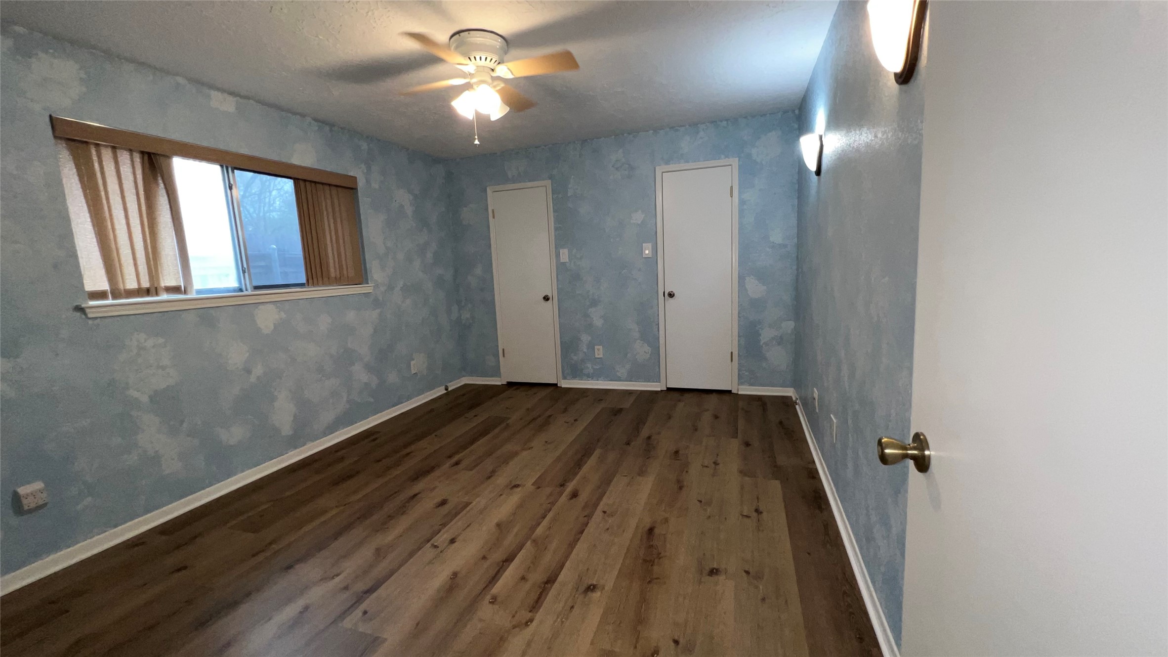 6615 Deer Ridge Lane Houston, TX 77086 - Photo 24 of 38 a view of a livingroom with wooden floor and a ceiling fan