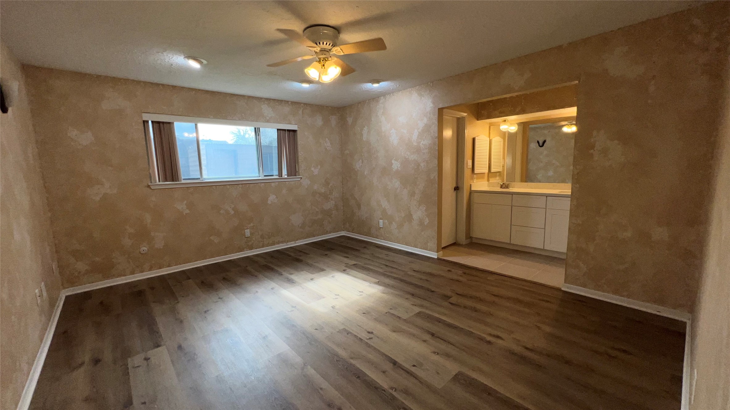 6615 Deer Ridge Lane Houston, TX 77086 - Photo 25 of 38 an empty room with wooden floor and windows