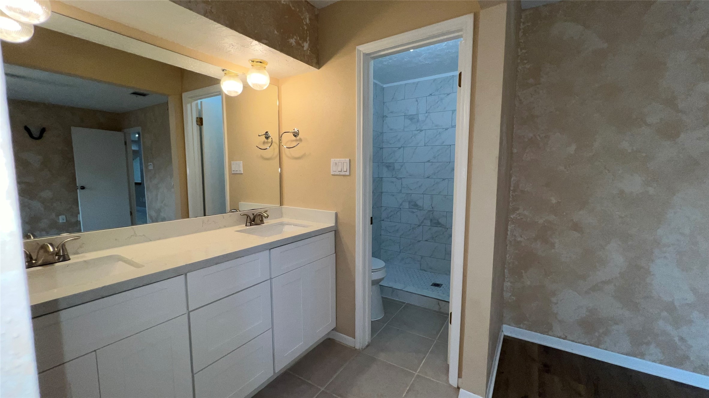 6615 Deer Ridge Lane Houston, TX 77086 - Photo 28 of 38 a bathroom with a granite countertop sink and a mirror