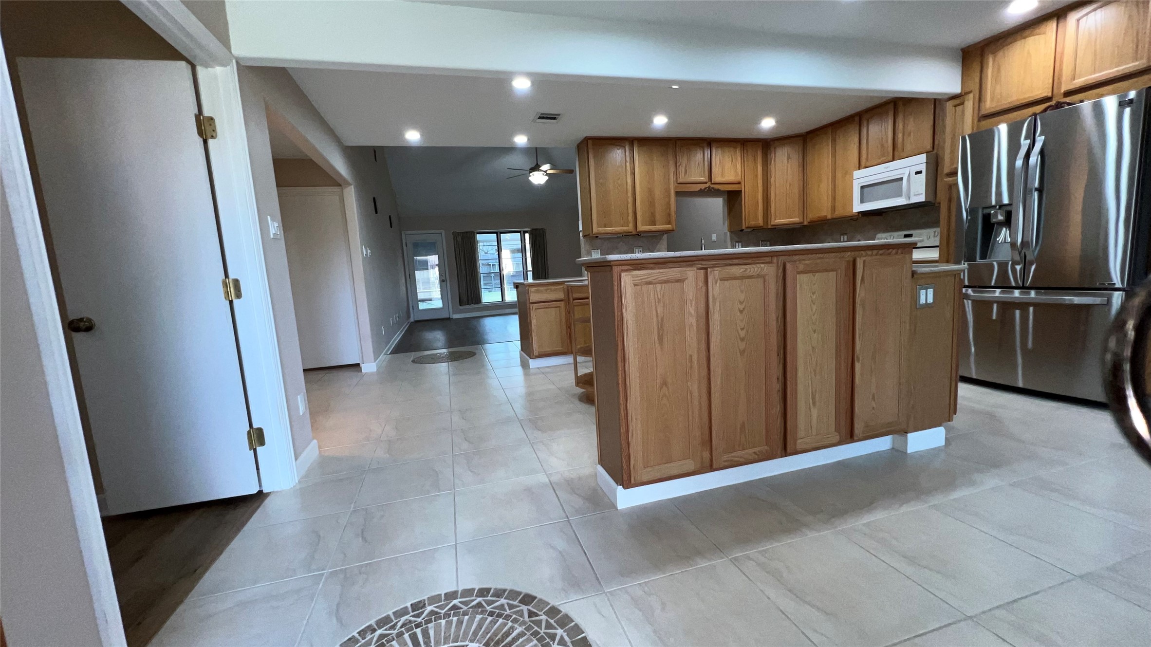6615 Deer Ridge Lane Houston, TX 77086 - Photo 8 of 38 a view of a hallway with a refrigerator