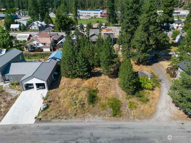 an aerial view of a house with a yard basket ball court and outdoor seating