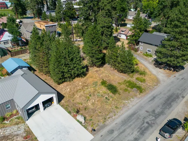 an aerial view of a house with a yard and trees