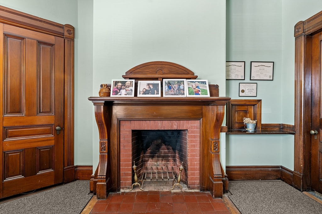 52 Cedar Street Worcester, MA 01609 - Photo 13 of 36 a living room with furniture and a fireplace