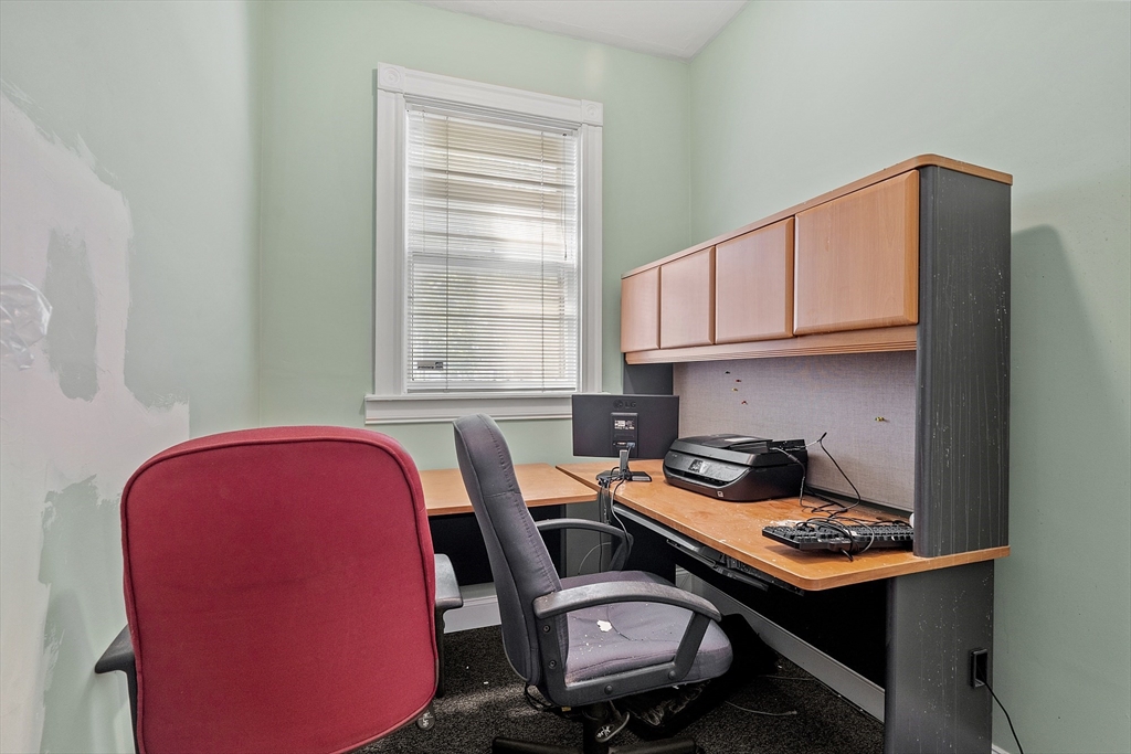 52 Cedar Street Worcester, MA 01609 - Photo 15 of 36 a room with a table chairs workspace and a window