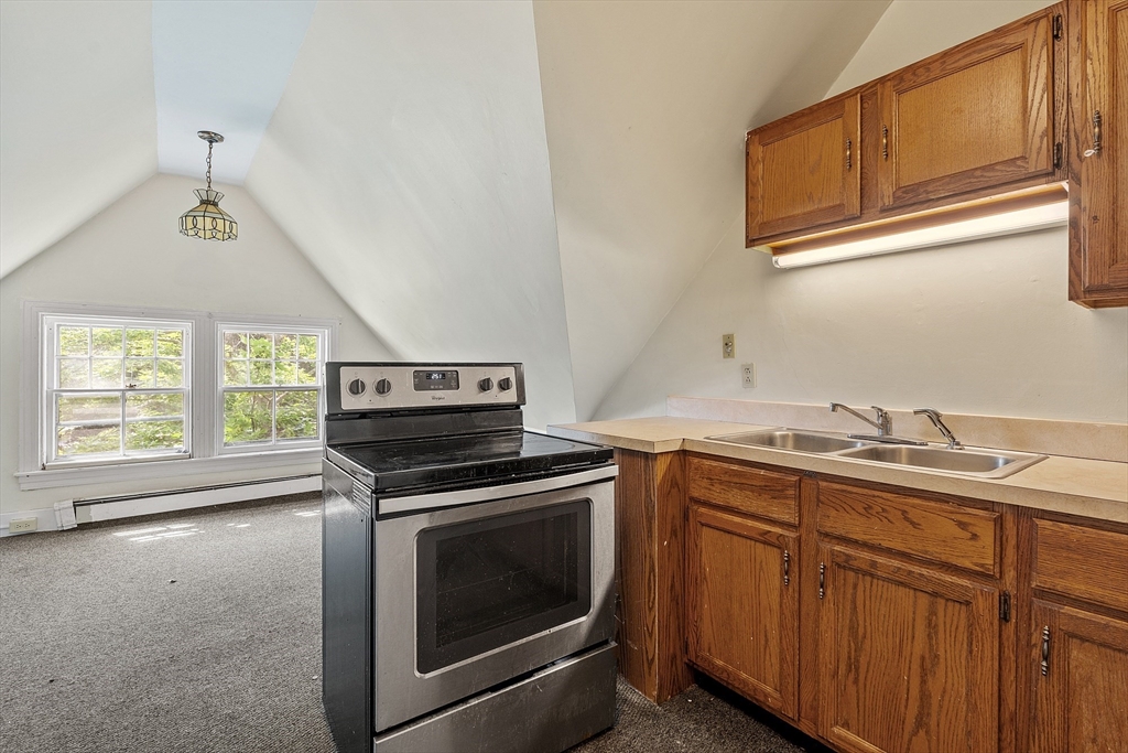 52 Cedar Street Worcester, MA 01609 - Photo 26 of 36 a kitchen with a stove and a sink