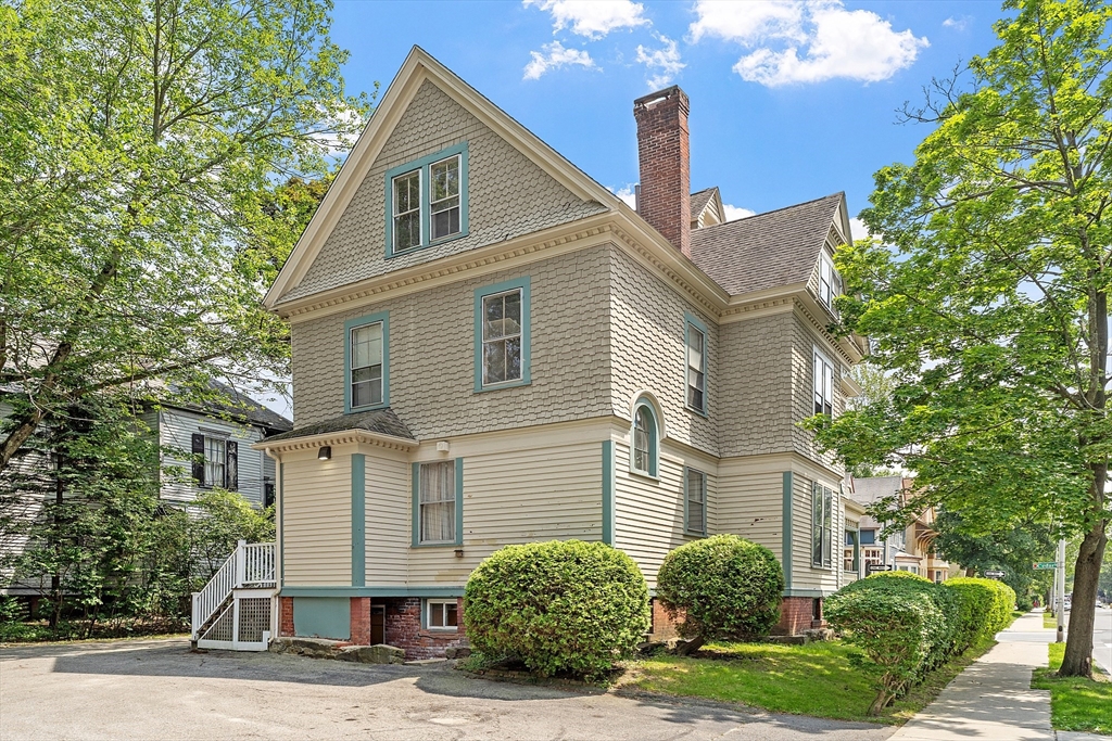 52 Cedar Street Worcester, MA 01609 - Photo 3 of 36 a front view of a house with a yard and trees