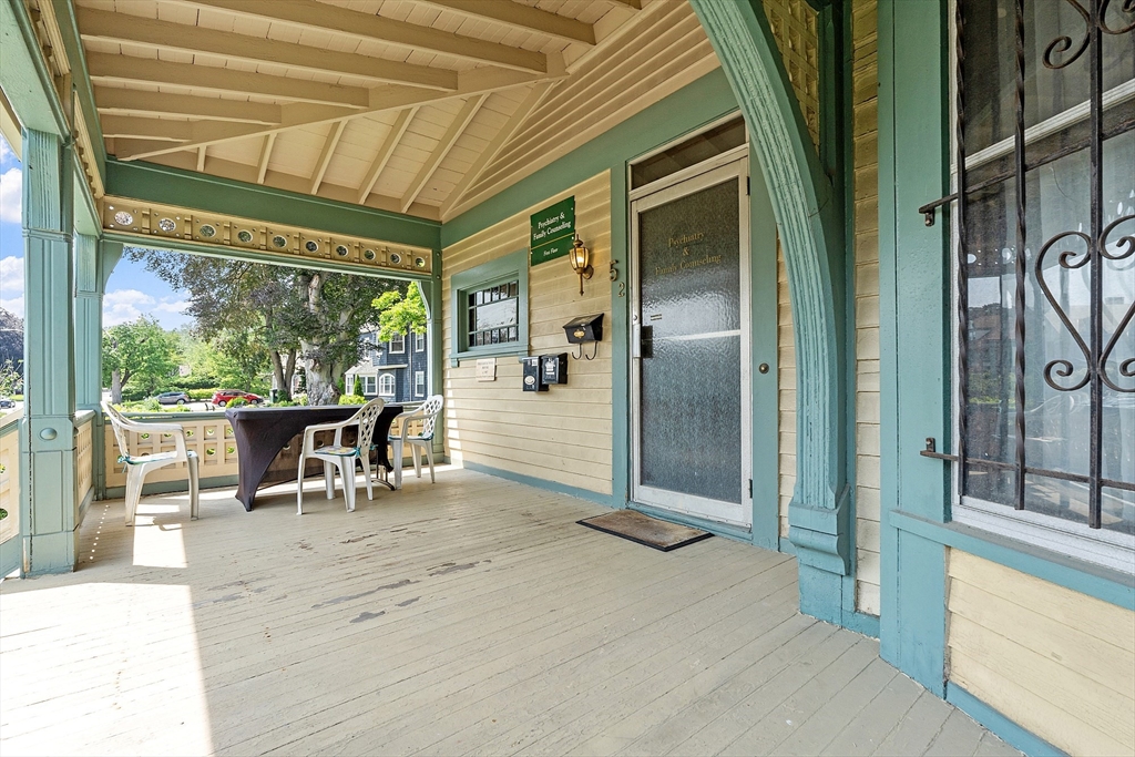 52 Cedar Street Worcester, MA 01609 - Photo 5 of 36 a view of a porch with chairs and backyard