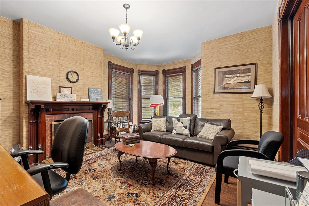 52 Cedar Street Worcester, MA 01609 - Photo 7 of 36 a living room with furniture a chandelier and a fireplace