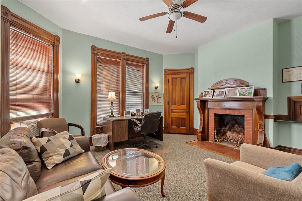 52 Cedar Street Worcester, MA 01609 - Photo 10 of 36 a living room with furniture and a fireplace
