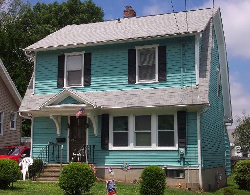48 Ridgely Avenue Fairfield, CT 06825 - Photo 1 of 1 a view of a brick house with a large windows and plants