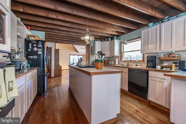 a living room with furniture a flat screen tv and a large window