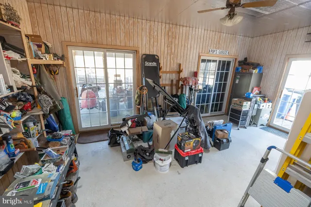a living room with furniture a flat screen tv and kitchen view