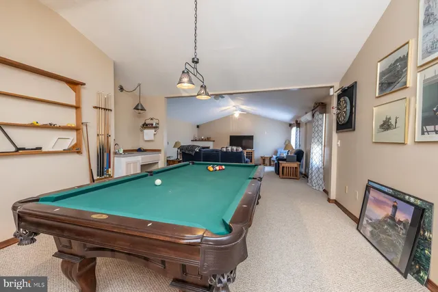 a spacious bedroom with a bed and a flat screen tv