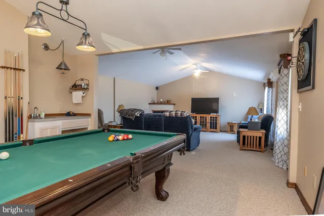 a spacious bedroom with a bed and a chandelier