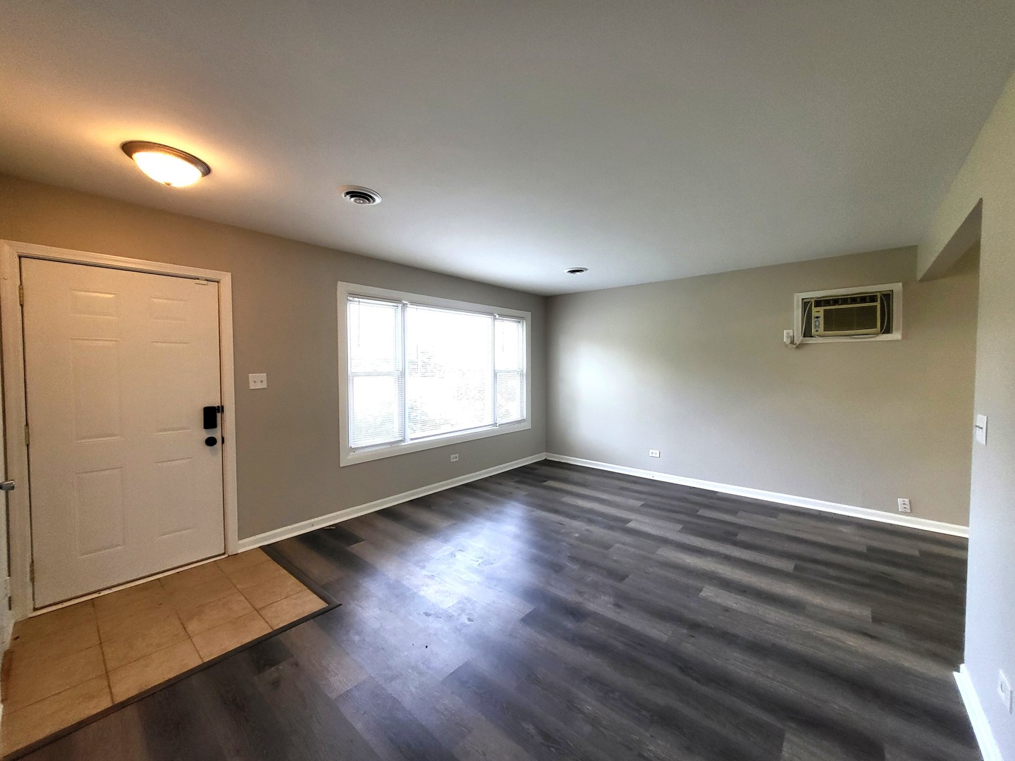 111 East 13th Street Lombard, IL 60148 - Photo 14 of 24 an empty room with wooden floor and windows