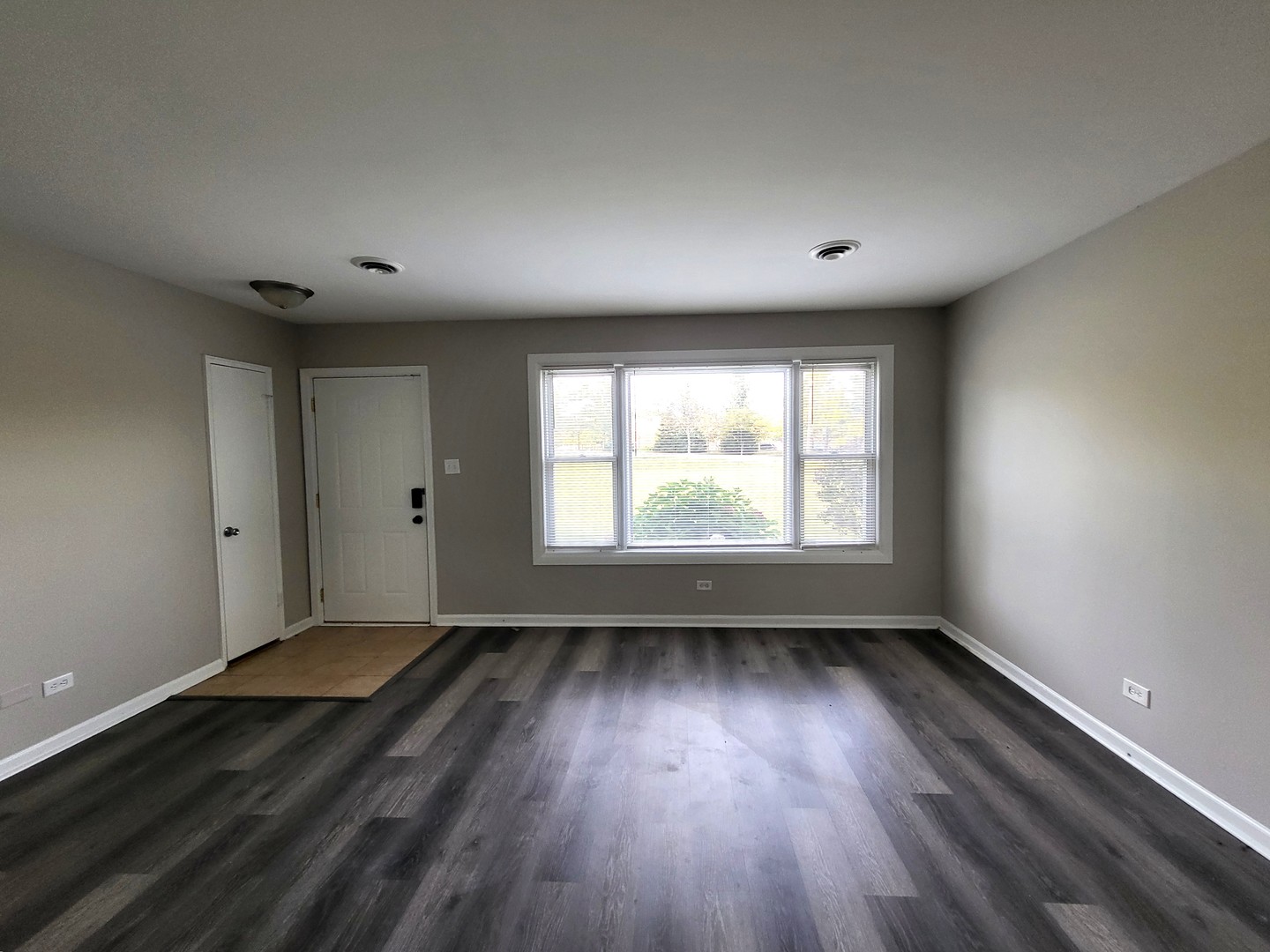 111 East 13th Street Lombard, IL 60148 - Photo 16 of 24 an empty room with wooden floor and windows