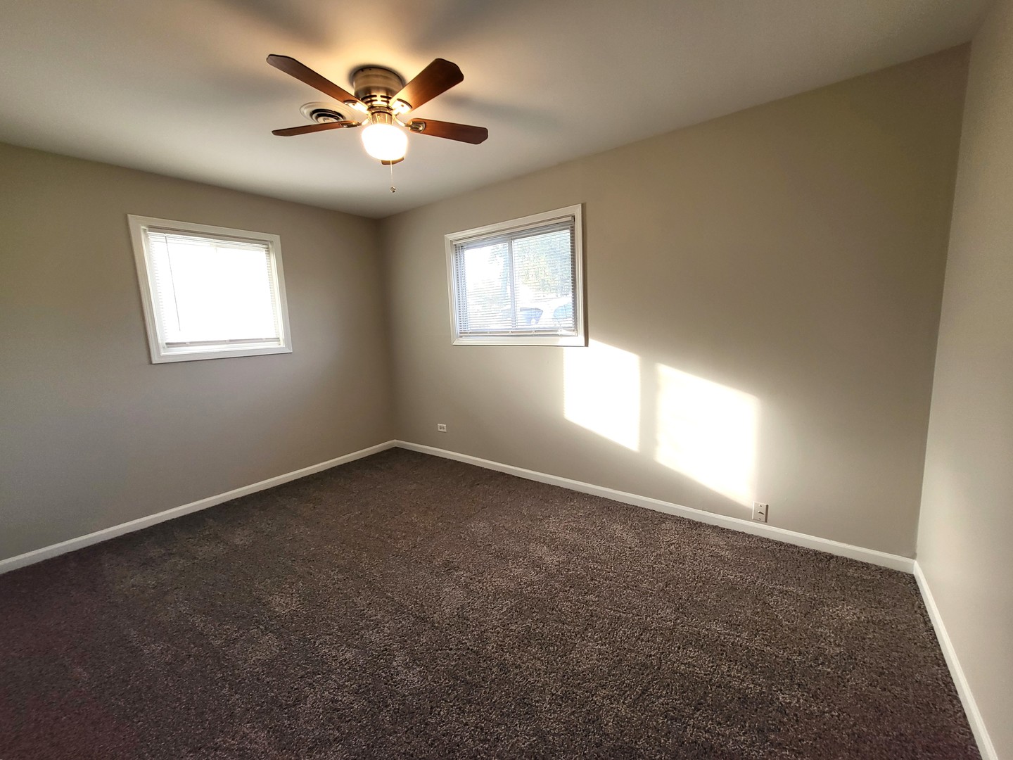 111 East 13th Street Lombard, IL 60148 - Photo 20 of 24 an empty room with windows and fan