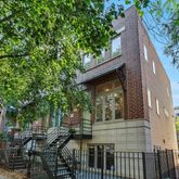 a view of house with backyard and sitting area