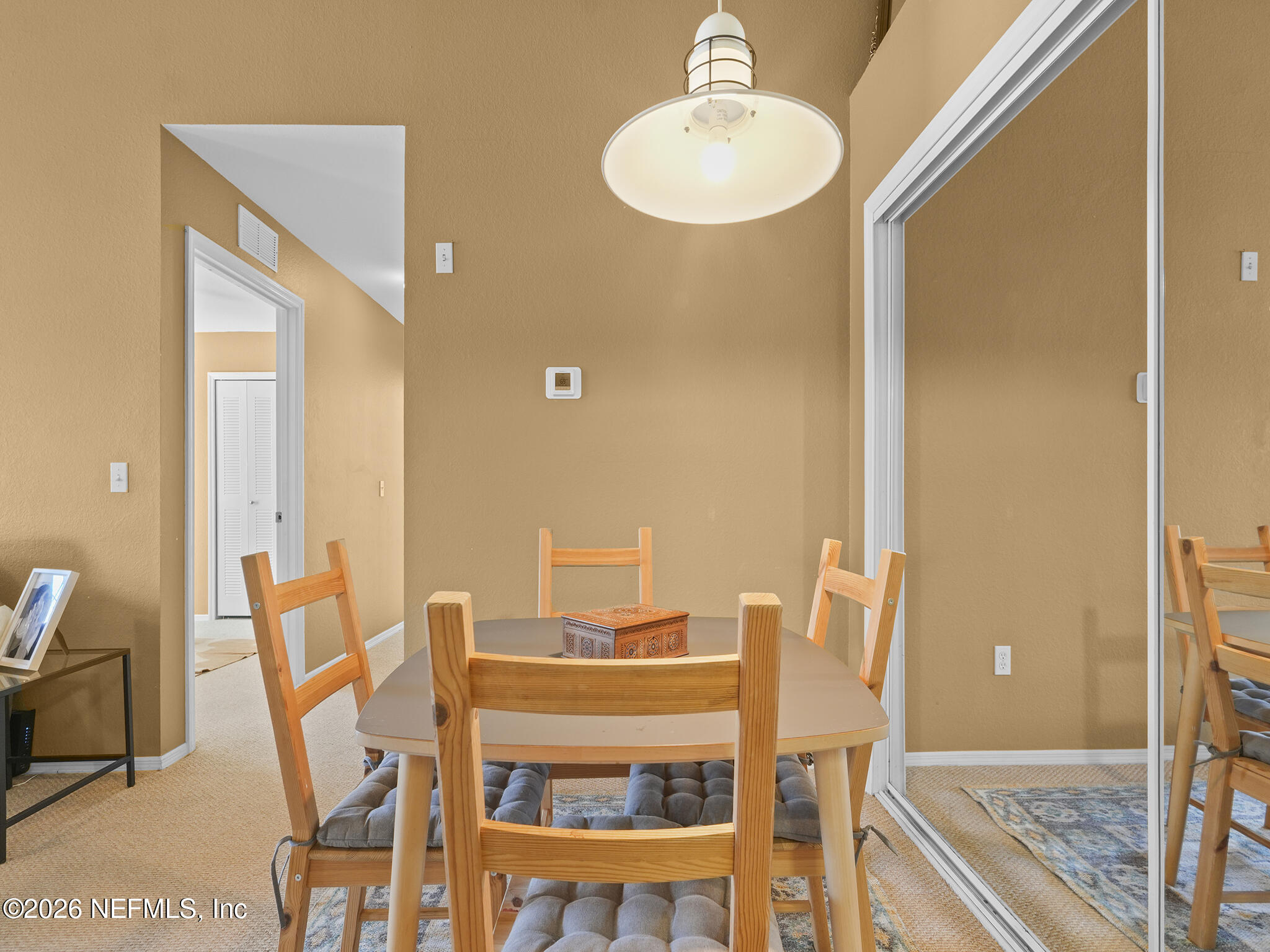 712 Lighthouse Road, Unit 712 Panama City Beach, FL 32407 - Photo 12 of 42 a view of a dining room with furniture and a chandelier