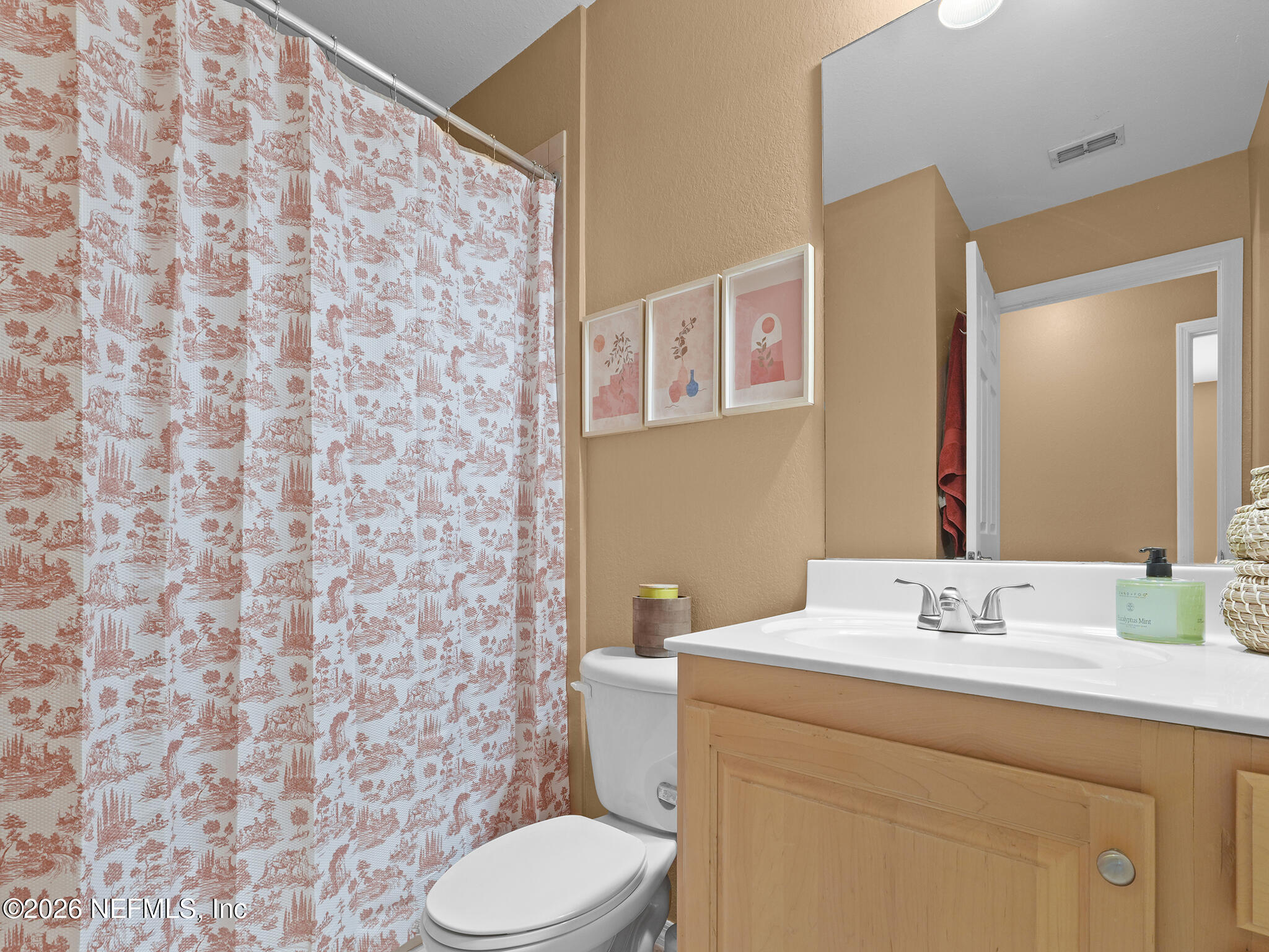 712 Lighthouse Road, Unit 712 Panama City Beach, FL 32407 - Photo 13 of 42 a bathroom with a sink a toilet and a mirror